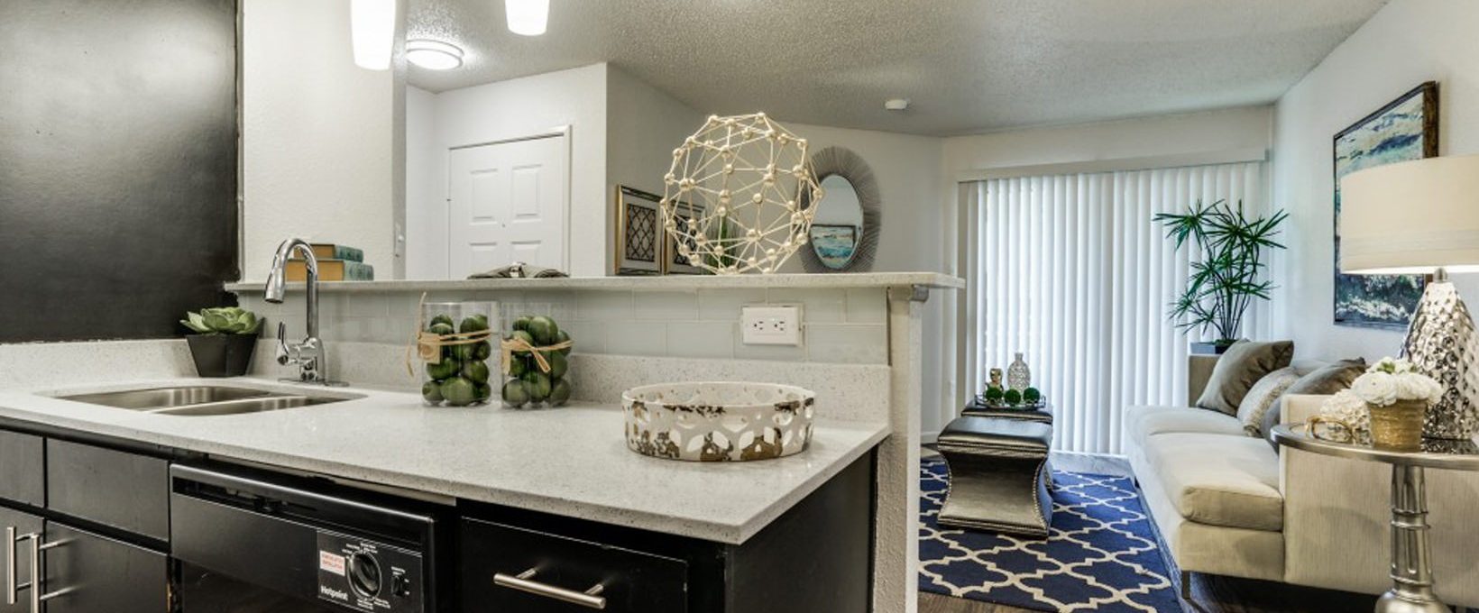 a kitchen with a black counter top and black cabinets at The Hudson