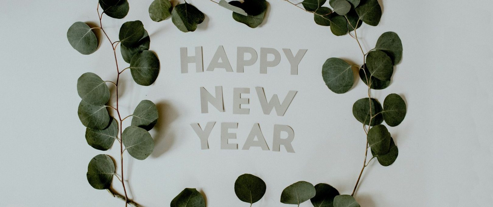 happy new year greeting card with eucalyptus leaves at The Hudson